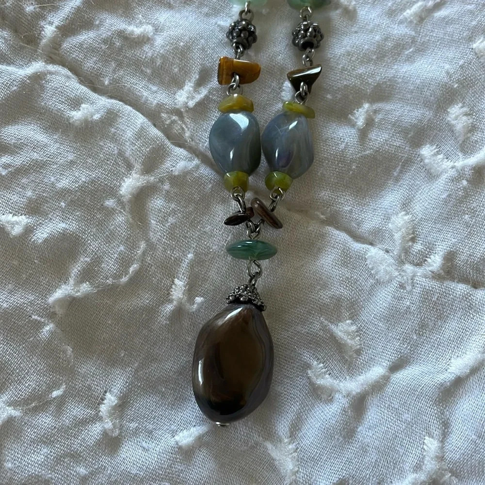 Beautiful necklace. Gray, brown and light aqua stones with silver tone accents.
